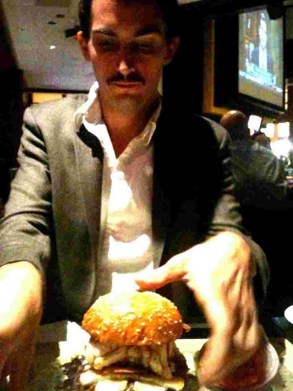 Ian prepares to eat the sandwich. Ian prepares to eat the sandwich.
