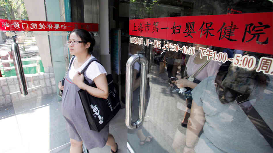 A pregnant Chinese woman walks out of a hospital in Shanghai in August 2010 A pregnant Chinese woman walks out of a hospital in Shanghai in August 2010