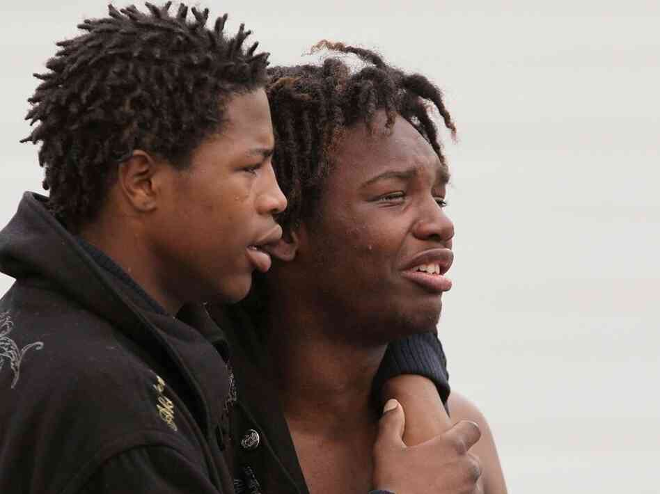 Young men grieve the murder of two teens in Chicago Young men grieve the murder of two teens in Chicago