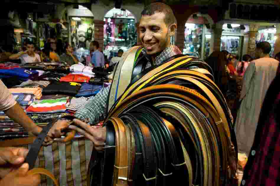 Despite its socialist roots, Egypt is now primarily a free-market economy with some state control. Here, a belt salesman carries his product around the market in the Ataba district of Cairo. 