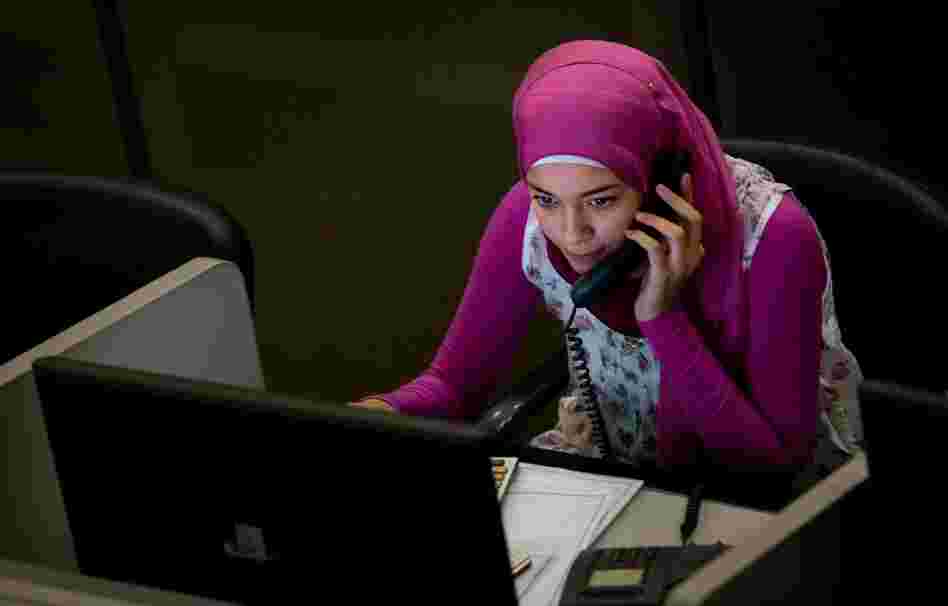 A woman works in her cubicle at the Egyptian Exchange in downtown Cairo. The exchange dates back more than 100 years — the Alexandria Stock Exchange was established in 1883, while the Cairo Stock Exchange was established in 1903. The two have since merged.