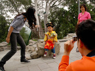 A Chinese family coaxes their son to pose in a "little emperor" costume at a Beijing park A Chinese family coaxes their son to pose in a "little emperor" costume at a Beijing park