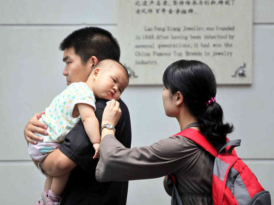 A Chinese family walks on a street in Shanghai A Chinese family walks on a street in Shanghai