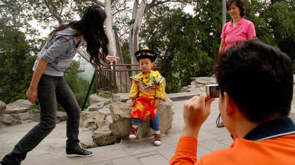 A Chinese family coaxes their son to pose in a "little emperor" costume at a Beijing park A Chinese family coaxes their son to pose in a "little emperor" costume at a Beijing park