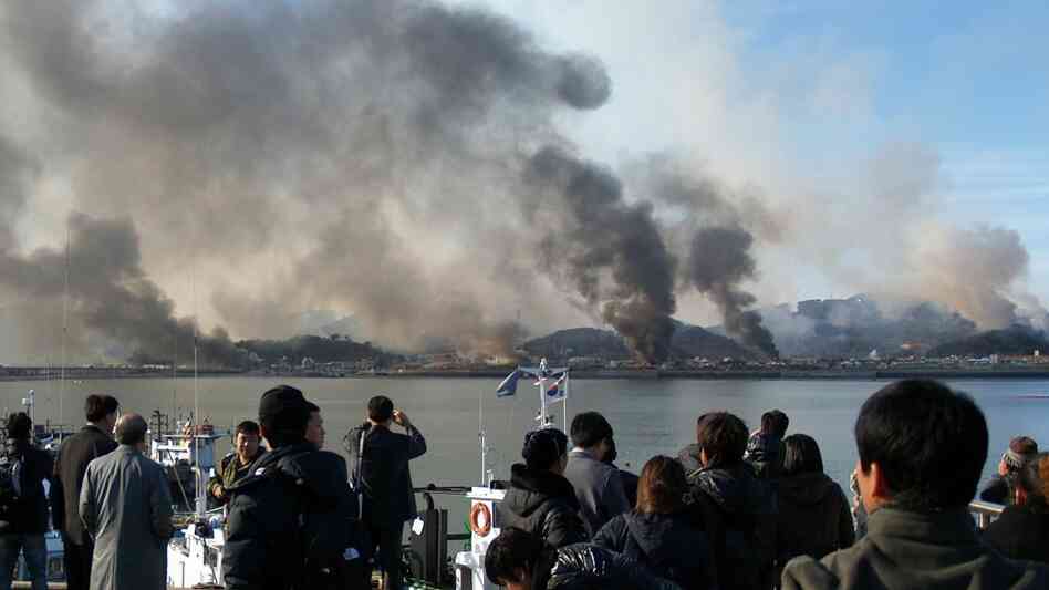 A picture taken by a South Korean tourist of smoke rising from Yeonpyeong Island earlier today. A picture taken by a South Korean tourist of smoke rising from Yeonpyeong Island earlier today.