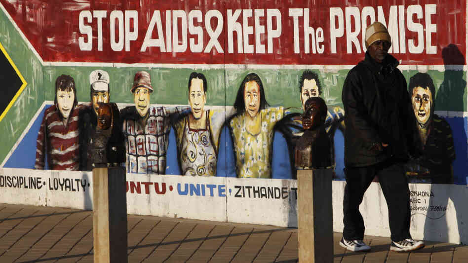Man walks by AIDS poster Man walks by AIDS poster
