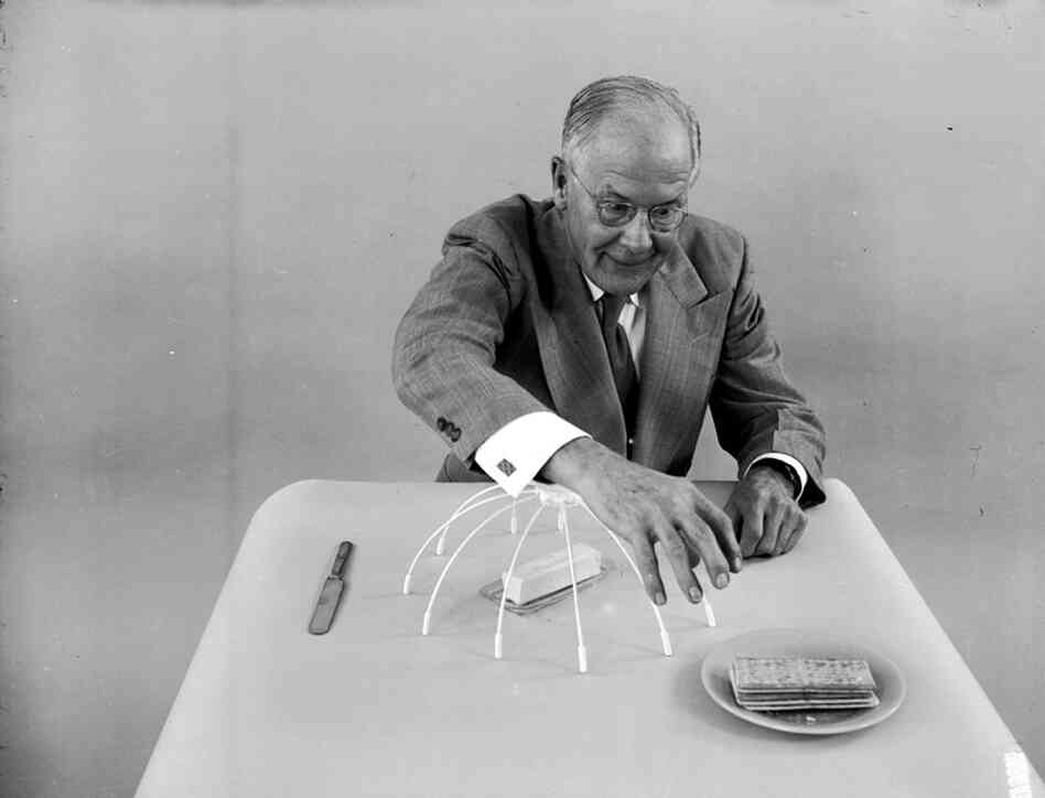 Oakes demonstrates his "sleeve protector" which covers a slab of butter to prevent him accidentaly touching it as he leans across a table. 
