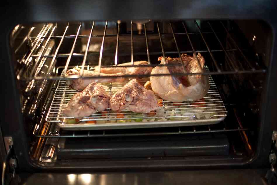 Kimball suggests slow-roasting turkey pieces over a baking sheet of onion, celery, carrot, thyme, garlic and broth.