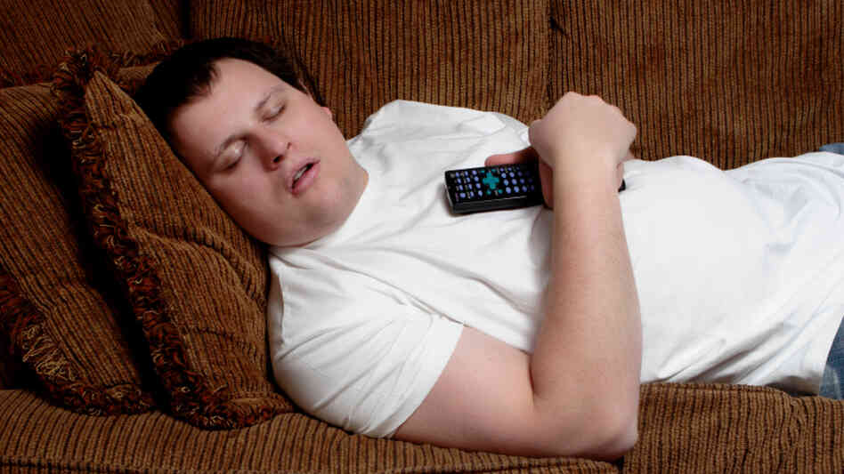 man lying asleep on his couch man lying asleep on his couch