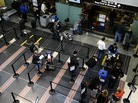 Travelers go through a security checkpoint at Reagan National Airport in Washington today. Travelers go through a security checkpoint at Reagan National Airport in Washington today.