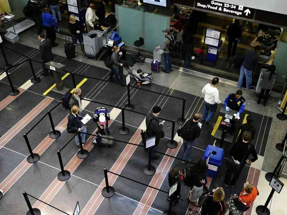 Travelers go through a security checkpoint at Reagan National Airport in Washington today. Travelers go through a security checkpoint at Reagan National Airport in Washington today.