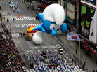 The Smurf balloon floats through Times Square during the Macy's Thanksgiving Day parade. The Smurf balloon floats through Times Square during the Macy's Thanksgiving Day parade.