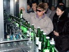 Kim Jong-Il at a bottling plant. Kim Jong-Il at a bottling plant.