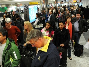 Travelers in a long check-in line Travelers in a long check-in line