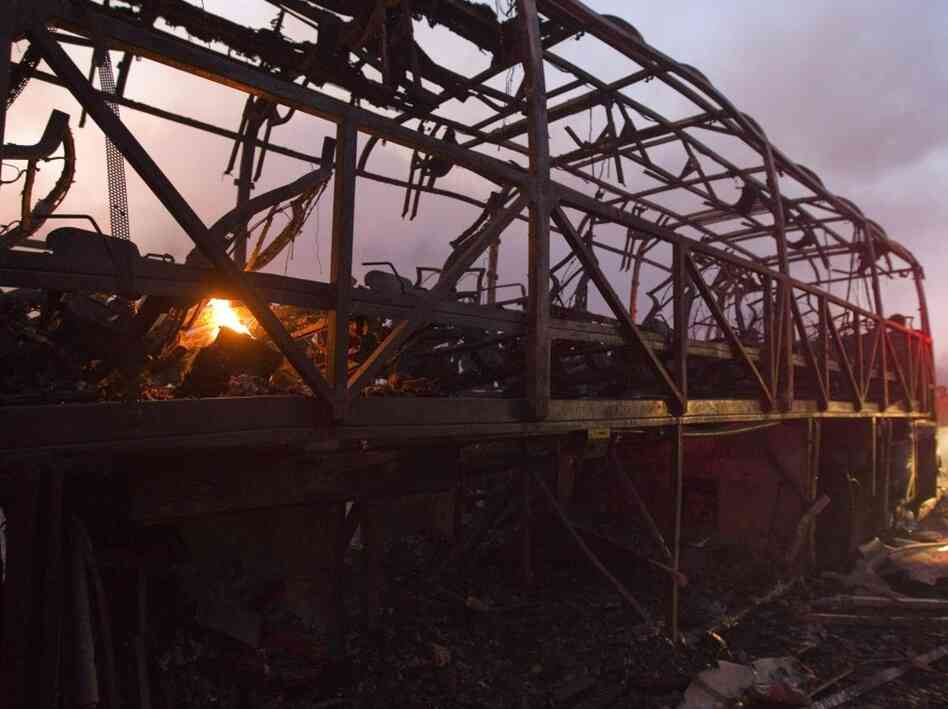 This bus was engulfed in flames, killing about 40 student prison guards. This bus was engulfed in flames, killing about 40 student prison guards.