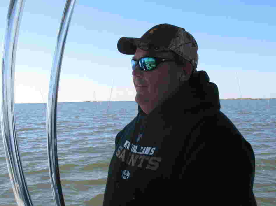Oysterman Mitch Jurisich steers a small boat around his family's oyster beds. 