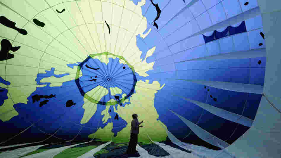 A Greenpeace activist checks a hot air balloon before sending it aloft in Mexico. A Greenpeace activist checks a hot air balloon before sending it aloft in Mexico.