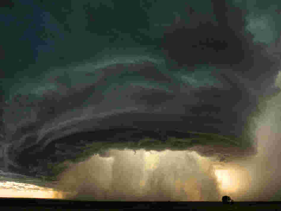 A supercell thunderstorm rolls across the Montana prairie at sunset. A supercell thunderstorm rolls across the Montana prairie at sunset.