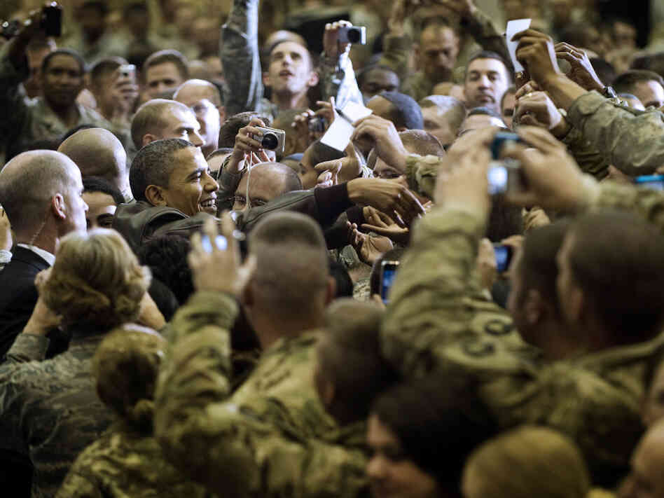 President Obama (at left) reaches out to troops at Bagram Air Field; Dec. 3, 2010. President Obama (at left) reaches out to troops at Bagram Air Field; Dec. 3, 2010.