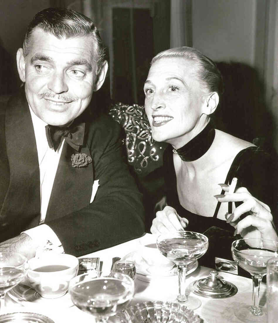 Clark Gable and Thompson celebrate her million-dollar nightclub deal to appear at Arnold Kirkeby's hotels in 1948.