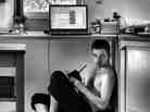 A man under a table and computer.