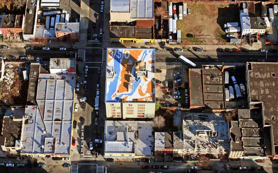 In New York City artist Molly Dilworth, famous for painting a mural in Times Square, created a design on a school rooftop that represents the New York and New Jersey coastline after a 7 meter rise in sea levels. 
