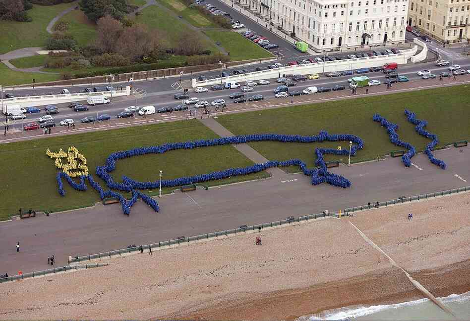 Nearly 2,000 people gathered in Brighton-Hove, UK and formed an image of King Canute, who futilely attempted to control the oceans according to legend. The image was designed by Radiohead's Thom Yorke. 