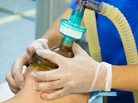 An anesthetist administering a gas to a patient An anesthetist administering a gas to a patient