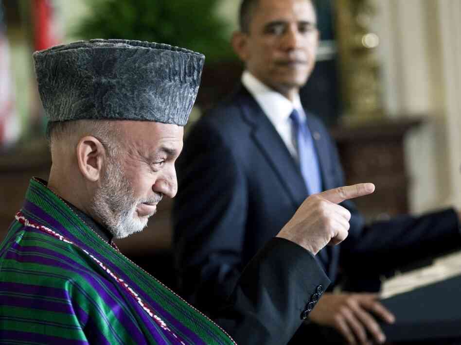 President Barack Obama watches as Afghanistan President Hamid Karzai speaks to a reporter President Barack Obama watches as Afghanistan President Hamid Karzai speaks to a reporter