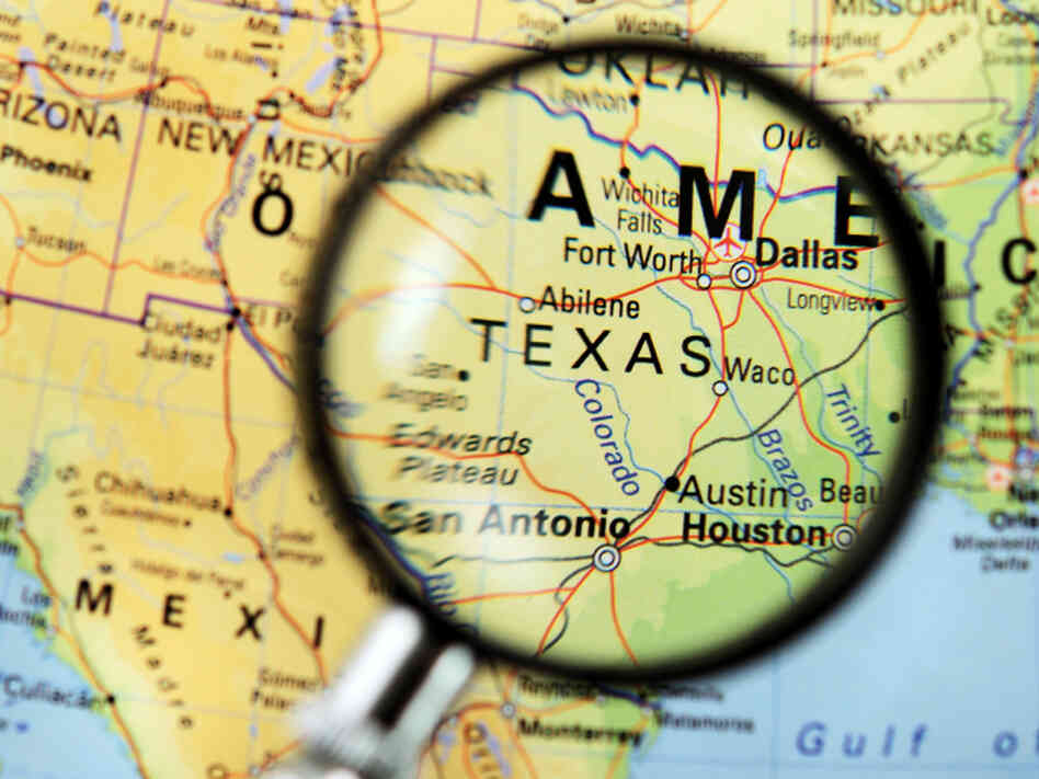 A magnifying glass zeroes in on Texas. A magnifying glass zeroes in on Texas.