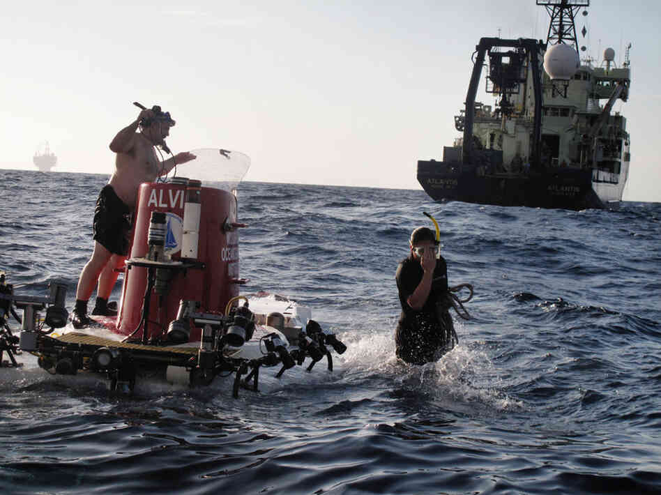 Once the deep-sea sub is in the water, swimmers Jerry Graham (left) and Kami Bucholz make final preparations for a dive. Alvin has made more than 4,600 dives around the world.