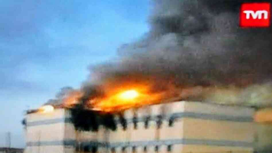 TV grab from Chile's TVN state-owned television channel showing the San Miguel prison in fire in San TV grab from Chile's TVN state-owned television channel showing the San Miguel prison in fire in San