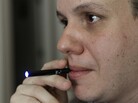 Galen Kipe puffs on an electronic cigarette in Ashboro, N.C. in August. Galen Kipe puffs on an electronic cigarette in Ashboro, N.C. in August.