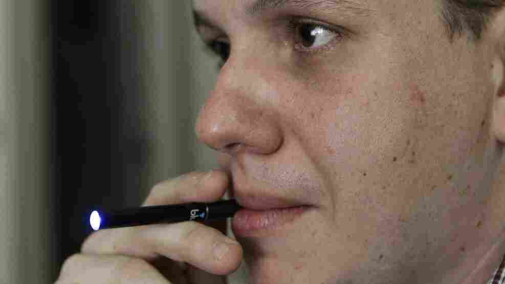 Galen Kipe puffs on an electronic cigarette in Ashboro, N.C. in August. Galen Kipe puffs on an electronic cigarette in Ashboro, N.C. in August.