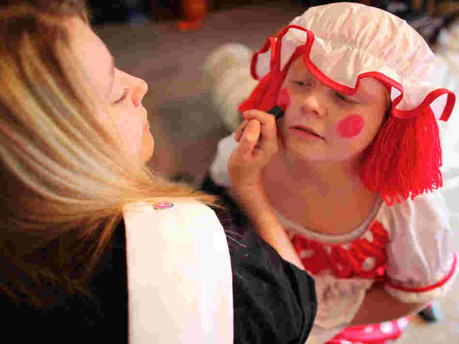 Michelle Fridley helps her daughter, Felicia, get dressed up to go to a Halloween party.