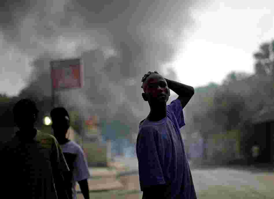 A boy looks down a ravaged street in Port-au-Prince.
