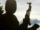 A rebel soldier holds an AK-47 assault rifle.