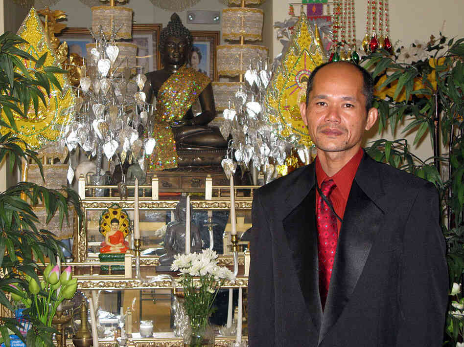 Van Suon stands in front of the shrine at the Buddhist Temple Van Suon stands in front of the shrine at the Buddhist Temple