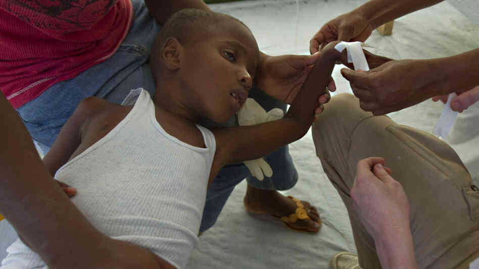 A boy being treated for cholera in Haiti. A boy being treated for cholera in Haiti.