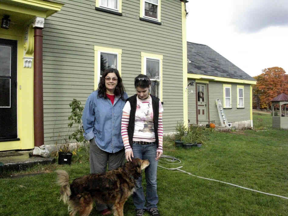 Rachel Keyser and her daughter, Sydney, stand in front of their house in Deerfield, N.H.