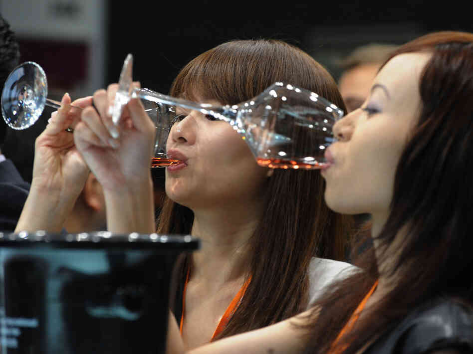 Visitors to the Hong Kong International Wine and Spirits Fair sample wine Visitors to the Hong Kong International Wine and Spirits Fair sample wine