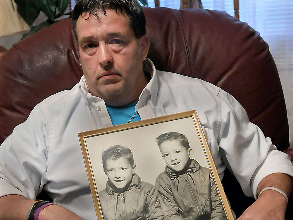 Gene Jones holds a mid-1960's photo of himself, right in photo, and his brother, Dean Jones