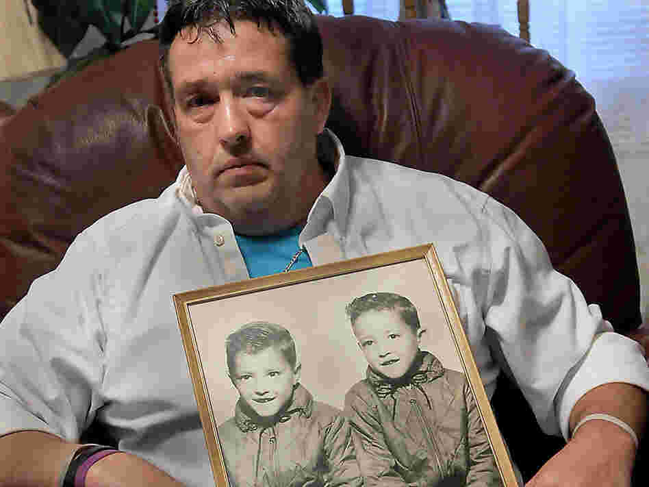 Gene Jones holds a mid-1960's photo of himself, right in photo, and his brother, Dean Jones