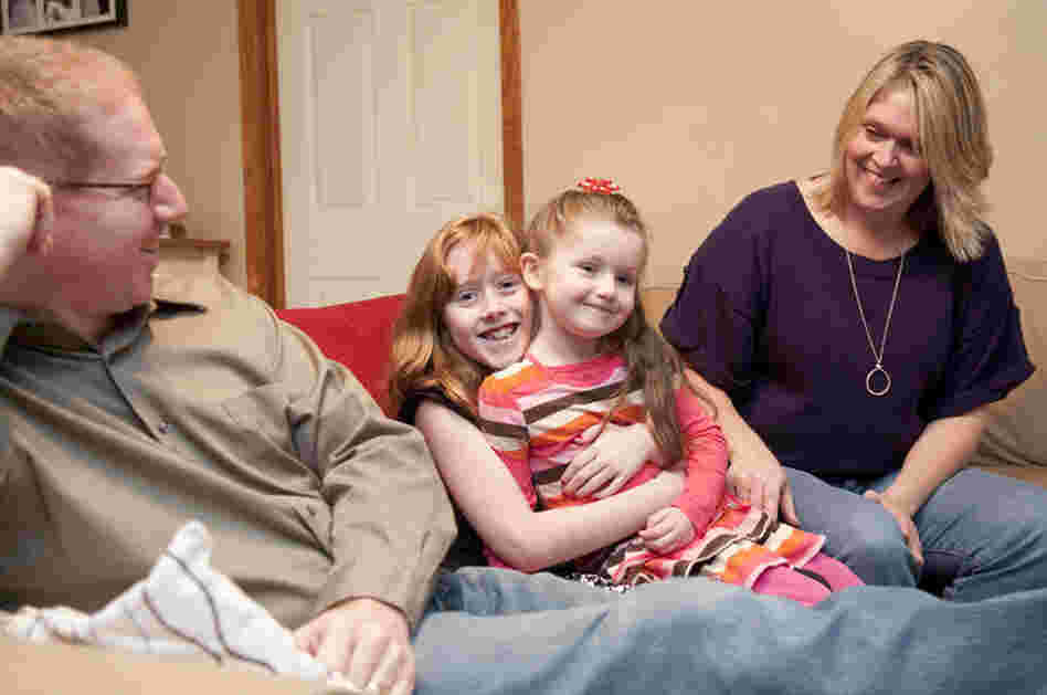 Madison, 9, holds her sister, Hannah, 4, with parents John and Kim Wells of Bettendorf, Iowa. During a routine ultrasound, Hannah was diagnosed with critical aortic stenosis, which leads to hypoplastic left heart syndrome. "It was the hardest day of our lives," Kim says.
