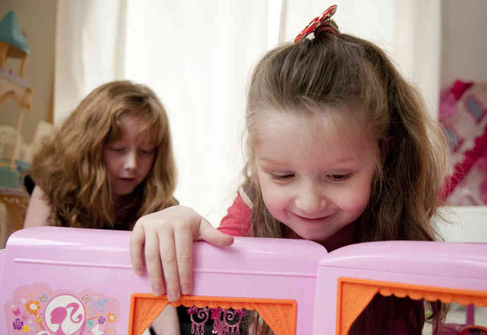 Hannah plays with her sister, Madison. "They had told us that if this had happened to our eldest child, who was born five years prior, that this would not have even been an option," John says.