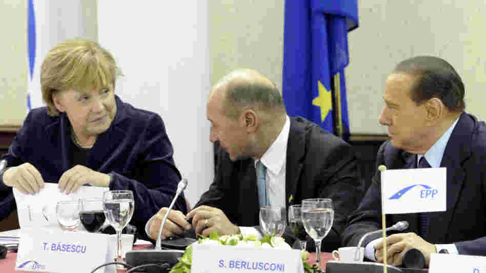 German Chancellor Angela Merkel spoke with Romanian President Traian Basescu (center) and Italian Prime Minister Silvio Berlusconi on Thursday ahead of a two-day EU summit in Brussels, Belgium.