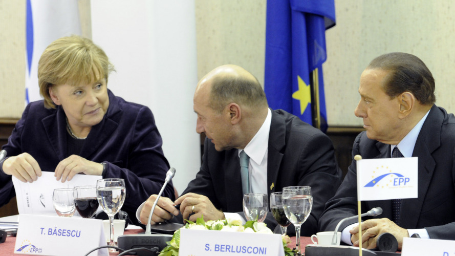 German Chancellor Angela Merkel spoke with Romanian President Traian Basescu (center) and Italian Prime Minister Silvio Berlusconi on Thursday ahead of a two-day EU summit in Brussels, Belgium.