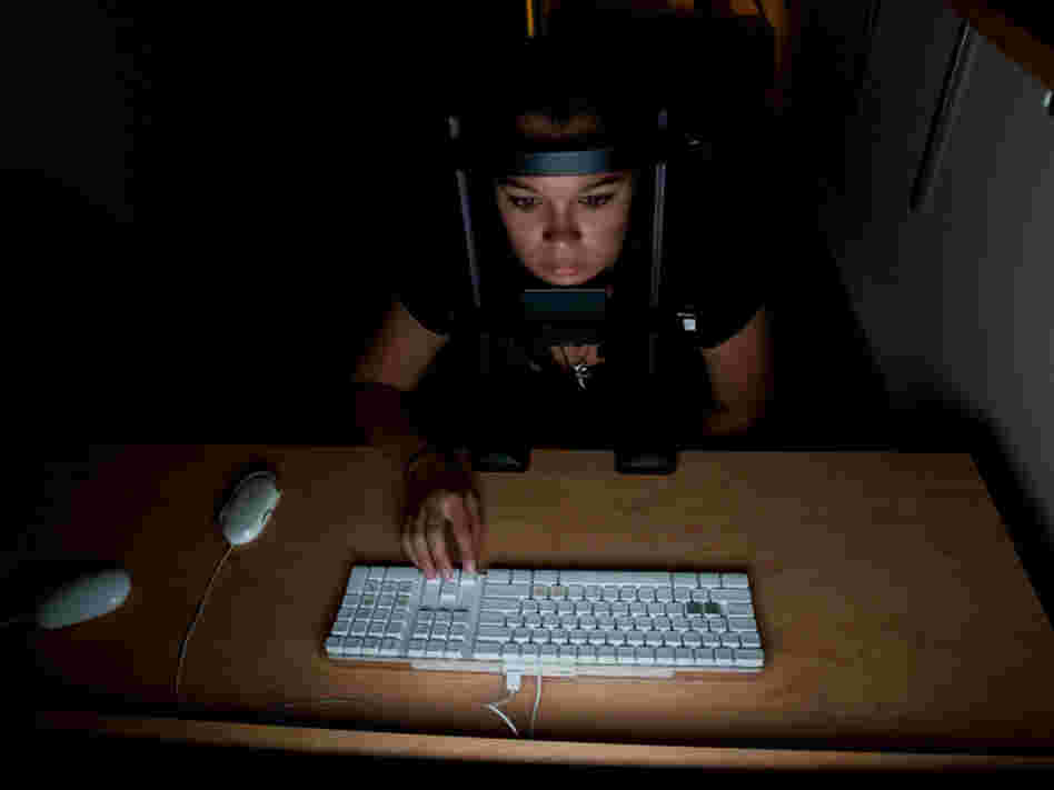 Test subjects in cognitive scientist Daphne Bavelier's study try to determine what direction erratically moving dots on a computer screen are going. 