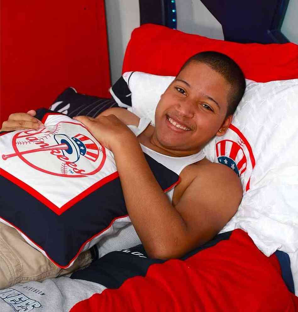 Eighteen-year-old Jesus German relaxes in his newly-transformed, Yankees-themed room in the Bronx. Blissful Bedrooms also arranged for German, who has spina bifida, to go to a Yankees game and meet his hero, Alex Rodriguez.