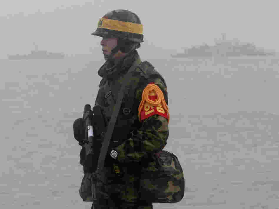 A South Korean marine stands guard on Yeonpyeong island on Friday.